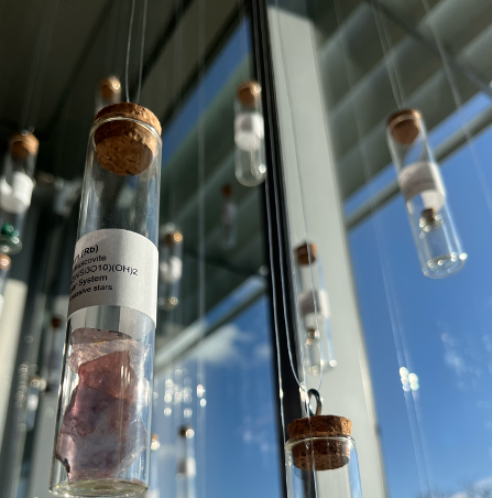 test tubes contain small objects as a material representation of the periodic table